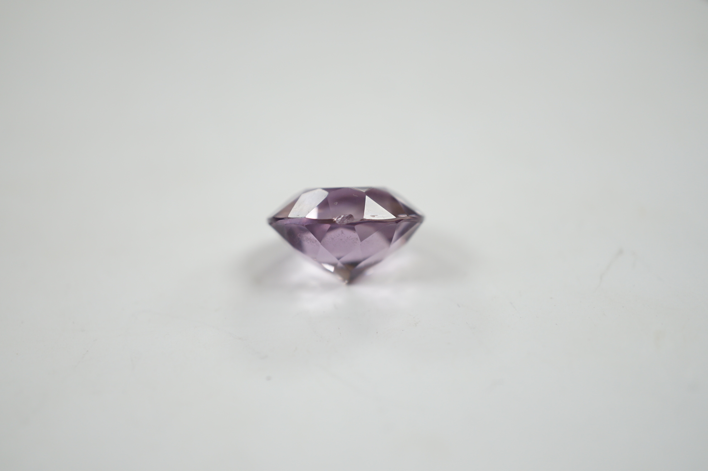 An unmounted round cut amethyst, weighing approximately 15.9ct.